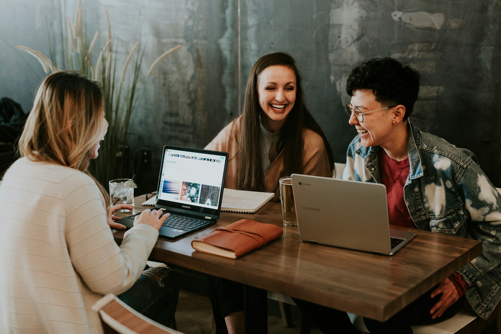 A small business team planning together with laptops